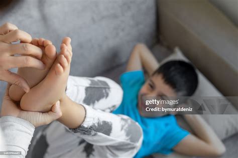 Mom Tickles Kids Feet High-Res Stock Photo - Getty Images