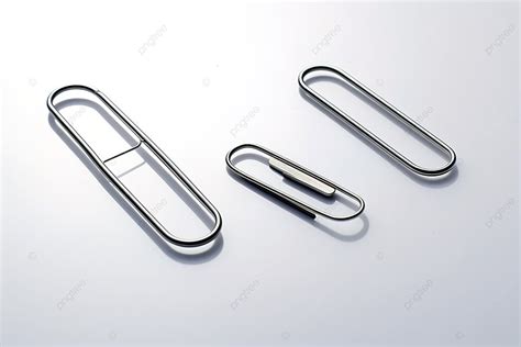 A Collection Of Three Paper Clip Shapes Laying On A White Surface ...