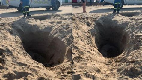 Coastguard fill in six foot sand hole at Mablethorpe beach in ...