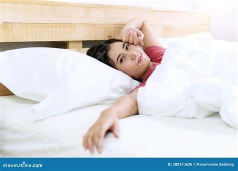 Cheerful Young Woman Lying Down with White Pillow after Wake Up on ...