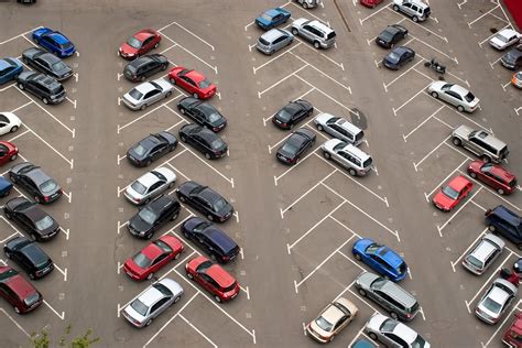 a parking lot filled with lots of different colored cars