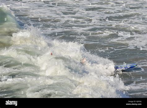 A surf board after a Surfer has wiped out Stock Photo - Alamy