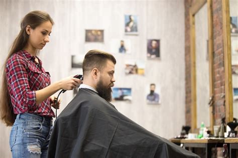 Free Photo | Barber woman serving client in barbershop