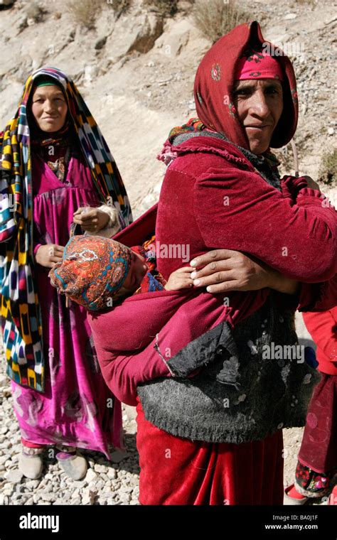 Tajik women with baby wearing traditional dress and hat, Marguzor Lakes ...