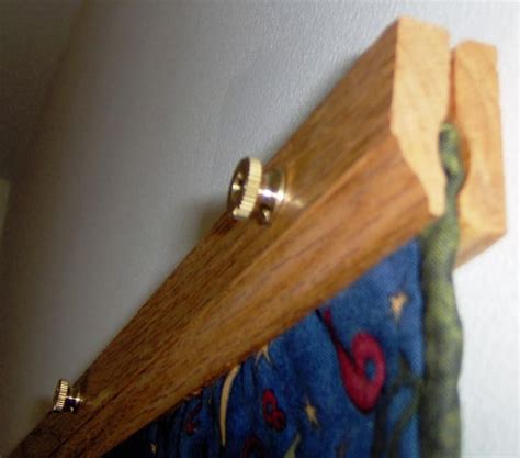 a close up of a wooden curtain rod