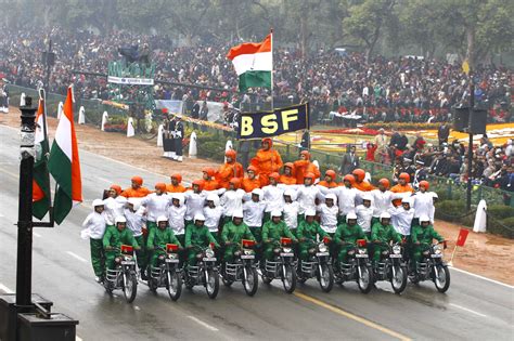 a large group of people riding bikes down a street in front of a flag ...