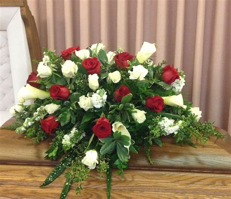 Casket spray of red and white roses along with calla lilies. Different ...