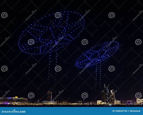 Illuminated Blue Drones Glowing in the Black Night Sky and Forming ...