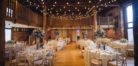 The Mill Barn at Gaynes Park wedding venue in Essex is set up for a ...