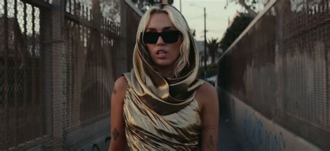 Miley Cyrus Wears Gold Cutout Dress in "Flowers" Music Video | POPSUGAR ...