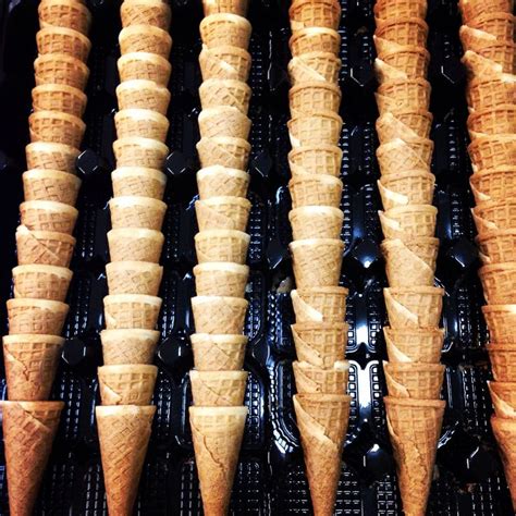 several cones of ice cream lined up in rows