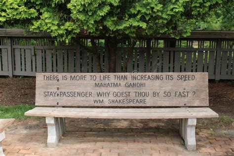 A Park Bench with a Engraved Quotes by Mahatma Gandhi and William ...