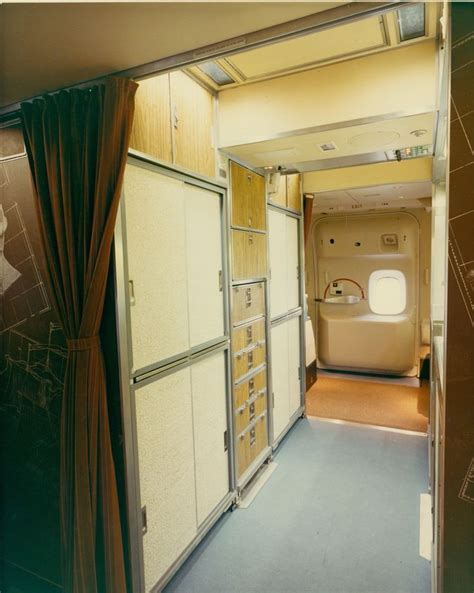 the inside of an airplane with lots of cabinets and curtains on either ...