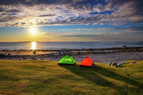 Camping at sunset with tents on Uttakleiv beach in Lofoten islands ...