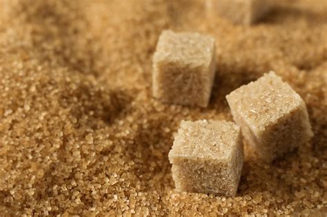 Premium Photo | Brown cane sugar crystals and cubes of refined cane ...