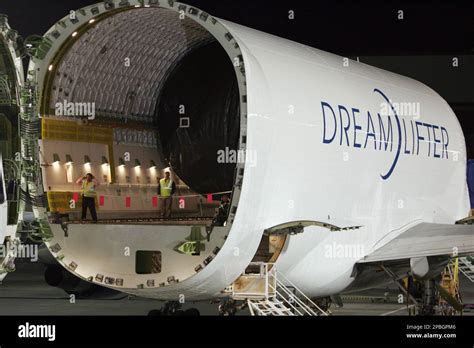 Boeing employees wait to unload the super freighter 'Dreamlifter ...