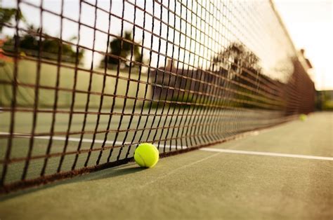 Premium Photo | Big tennis ball at the net, nobody, outdoor court ...