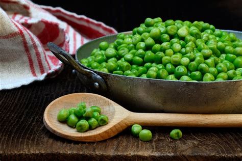 Defrosted green peas in shell with cooking spoon - Photo12-imageBROKER ...