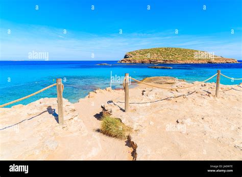 Entrance and path to beautiful Cala Comte beach famous for its azure ...