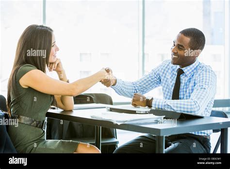 Business people shaking hands in meeting Stock Photo - Alamy