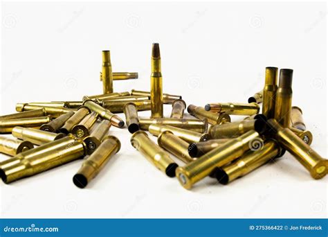 Pile of Gold Bullets and Empty Casings from Gun Laying on White ...