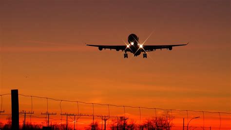 Plane Landing At Sunset