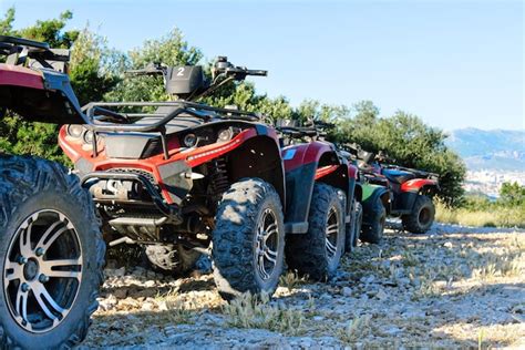 Premium Photo | Parked atv and utv mountain road parked in a row ...