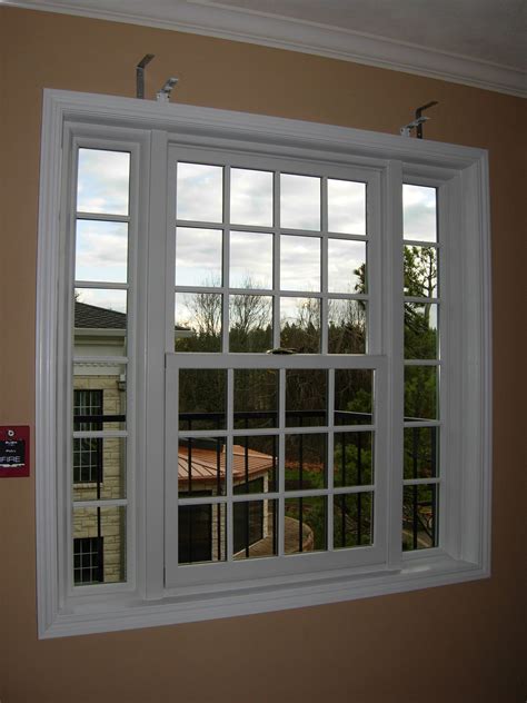 This is a double hung/picture combination window with colonial style ...