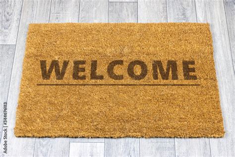 Welcome door mat on grey vinyl floor Stock Photo | Adobe Stock