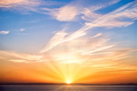 Sunrise with Sun, Sun Rays, Blue Sky, Clouds and Sea Stock Photo ...