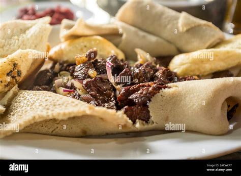 Tibs and injera served at a siga bet (a combined butcher and restaurant ...