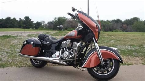 a red and black motorcycle parked on the side of a road in front of ...