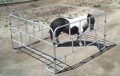 A square lightweight corral encloses a pony