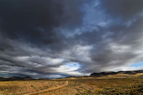 Overcast sky over vast valley and hilltops · Free Stock Photo