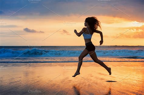 Girl running by sunset beach | Sports & Recreation Stock Photos ...