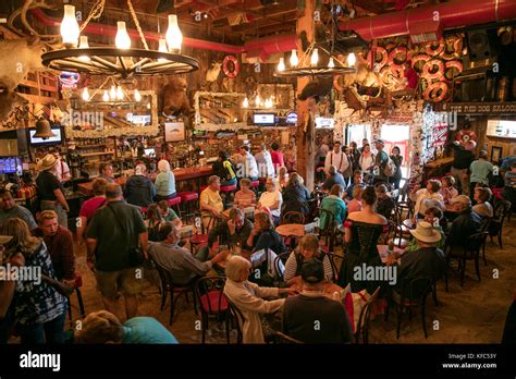 USA, Alaska, Juneau, individuals gather and dine inside of the Red Dog ...