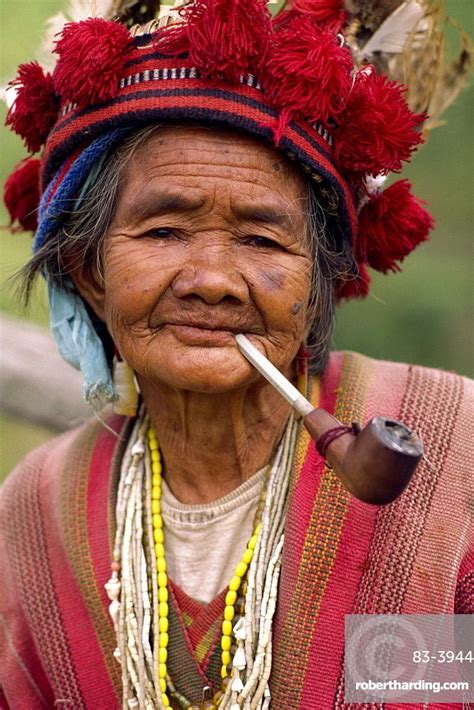 Portrait of an elderly woman of the Ifugao tribe wearing a woven hat ...