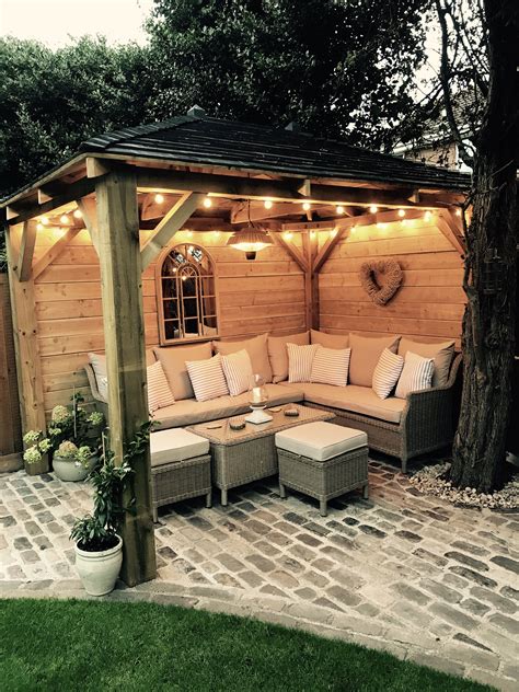 Homemade wooden gazebo, cobbles, garden lights, outdoor sofa, outdoor ...