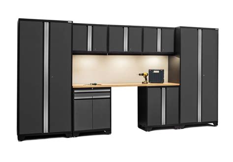 an office cubicle with black cabinets and white walls