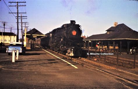 PRR K4 #612 with commuter train at Belmar, N.J. station on the New York ...