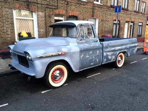 ’59 Chevy pickup undergoing restoration, right on a street in London