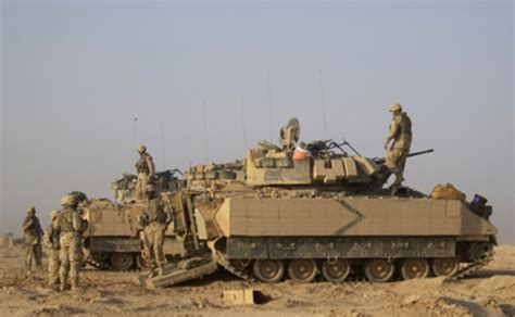 U.S. Army soldiers prepare themselves and their M2A2 Bradley Fighting ...