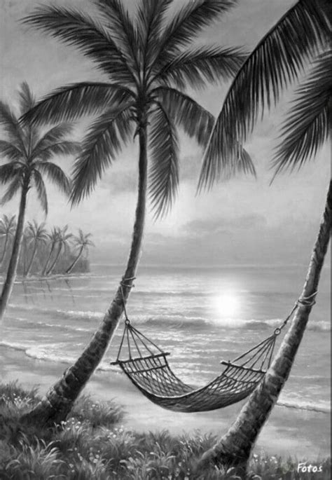 a black and white photo of a hammock between two palm trees on the beach