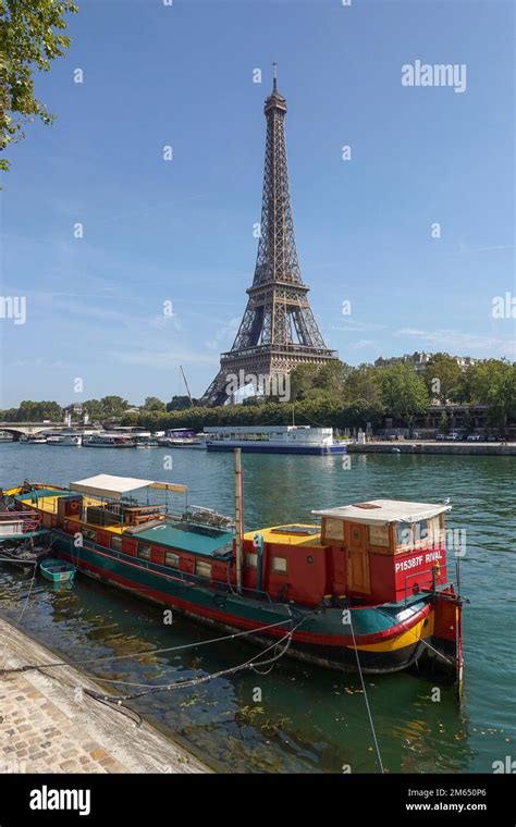 France, Paris, Boats anchored on the Seine river and view on Eiffel ...