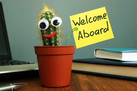 Welcome aboard concept. Funny cactus on workplace in the office.