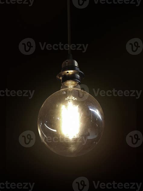 Glowing light bulb on dark background 8614327 Stock Photo at Vecteezy