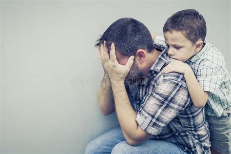 Sad Son Hugging His Dad Near Wall Stock Photo - Image of crying, child ...