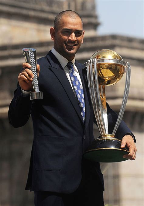 MS Dhoni with the World Cup trophy and his Man of the Match award from ...