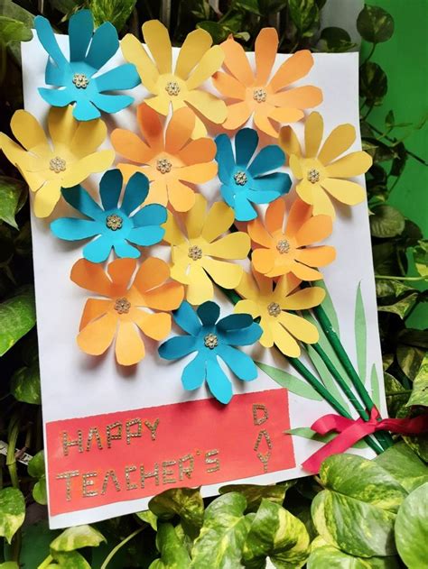 a card with flowers made out of paper