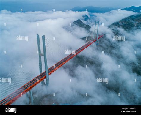 An aerial view of Beipanjiang Bridge or Beipan River Bridge in clouds ...